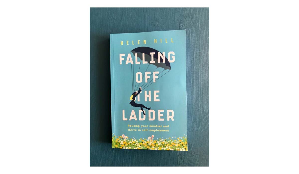 Falling Off The Ladder book on a blue wooden background