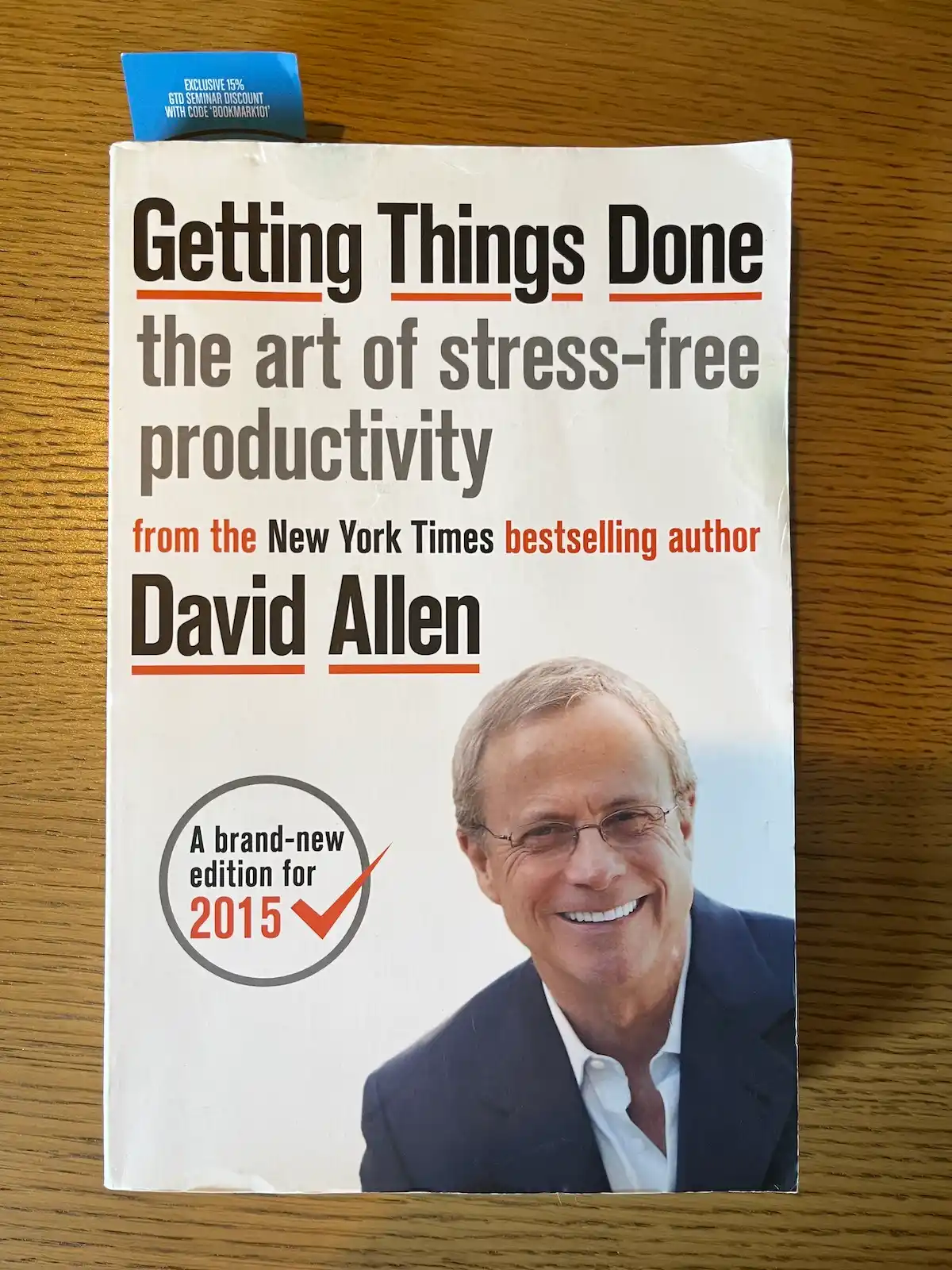 David Allen's Getting Things Done book on a wooden background.