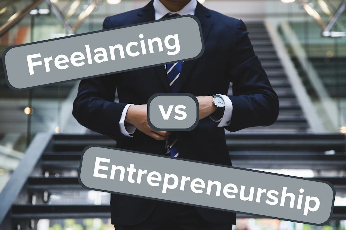 Man in a suit with stairs behind him with the text "Freelancing vs Entrepreneurship".